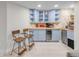 Basement bar area with blue cabinets, tile backsplash, beverage cooler, and two bar stools at 1644 S Garfield St, Denver, CO 80210