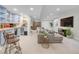 Finished basement area featuring a wet bar with seating, TV, and ample living space at 1644 S Garfield St, Denver, CO 80210