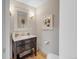 Stylish powder room featuring a dark vanity with marble countertop, elegant lighting, and decorative accents at 1644 S Garfield St, Denver, CO 80210