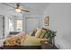 Inviting bedroom featuring a ceiling fan, large window, and modern decor at 1644 S Garfield St, Denver, CO 80210