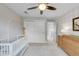 A well-lit Bedroom featuring a white crib, large closet, soft rug, and changing table at 1644 S Garfield St, Denver, CO 80210