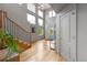 Bright foyer featuring hardwood floors, a staircase, and a modern chandelier at 1644 S Garfield St, Denver, CO 80210