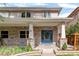 Exterior front door with stone accents and a manicured lawn at 1644 S Garfield St, Denver, CO 80210