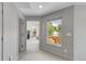 Hallway with hardwood floors, natural light from the window, and views of the backyard pergola at 1644 S Garfield St, Denver, CO 80210