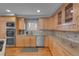 Bright kitchen with wood cabinets, granite countertops, stainless steel appliances, and modern fixtures at 1644 S Garfield St, Denver, CO 80210