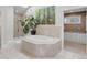 Ensuite bathroom features a jacuzzi bathtub, skylight, and glass-enclosed shower at 1644 S Garfield St, Denver, CO 80210