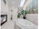 Relax in this ensuite bathroom with a soaking tub, fireplace, and bright skylights at 1644 S Garfield St, Denver, CO 80210