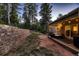 Backyard patio with an outdoor seating area, string lights, and retaining wall at 6100 Apache Dr, Larkspur, CO 80118