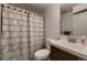 Bathroom with a patterned shower curtain, ample lighting, and a dark wood vanity at 6100 Apache Dr, Larkspur, CO 80118