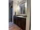 Bathroom vanity features dark wood cabinets, modern pendant lights, and stylish finishes at 6100 Apache Dr, Larkspur, CO 80118