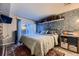 Bedroom with a sliding glass door to outdoor seating and a textured wall with trendy decor at 6100 Apache Dr, Larkspur, CO 80118