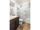 Full bathroom featuring neutral colors, a shower-tub combo, and a floral shower curtain at 18651 E 53Rd Ave, Denver, CO 80249