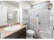 Bathroom featuring neutral colors, a shower-tub combo, and a floral shower curtain at 18651 E 53Rd Ave, Denver, CO 80249