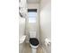 Cozy half-bathroom with neutral decor, decorative shelf and a single window at 18651 E 53Rd Ave, Denver, CO 80249