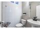 Stylish half-bathroom features textured white tile walls and a modern sink at 18651 E 53Rd Ave, Denver, CO 80249