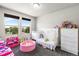 Bright bedroom with toys, multiple windows, a changing table, and white trim at 18651 E 53Rd Ave, Denver, CO 80249