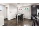Bright dining area features modern lighting, hardwood floors, and views from the windows at 18651 E 53Rd Ave, Denver, CO 80249