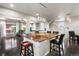 Kitchen island features pendant lighting and seating in an open concept layout at 18651 E 53Rd Ave, Denver, CO 80249