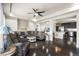 Open-concept living room with hardwood floors, modern ceiling fan, and comfortable seating at 18651 E 53Rd Ave, Denver, CO 80249