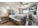 Serene main bedroom with ample natural light, hardwood floors, and stylish furnishings at 18651 E 53Rd Ave, Denver, CO 80249