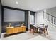 Basement media room with a large screen and dining table near the staircase at 6237 Stable View St, Castle Pines, CO 80108