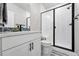 Bathroom featuring a glass-enclosed shower, modern fixtures, and a sleek white vanity at 6237 Stable View St, Castle Pines, CO 80108