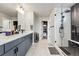 Elegant bathroom showcasing walk-in shower, double sinks, and marble tile flooring at 6237 Stable View St, Castle Pines, CO 80108