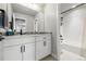 Bathroom featuring a white vanity with decorative backsplash and a shower-tub combination at 6237 Stable View St, Castle Pines, CO 80108