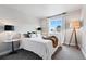 Bright bedroom featuring a queen bed, stylish lamps, and a window with natural light at 6237 Stable View St, Castle Pines, CO 80108