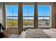 Bedroom view showcasing expansive windows and stunning mountain scenery at 6237 Stable View St, Castle Pines, CO 80108