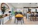 Open concept dining room showcases modern table, hardwood floors, and seamless flow to the kitchen at 6237 Stable View St, Castle Pines, CO 80108