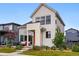 Attractive home with a covered porch, orange front door, and manicured lawn with flower beds at 6237 Stable View St, Castle Pines, CO 80108