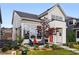 Charming home with an orange front door, covered porch, and well-manicured landscaping at 6237 Stable View St, Castle Pines, CO 80108