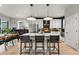This kitchen features white cabinets, stainless steel appliances, island seating, and an adjacent dining area at 6237 Stable View St, Castle Pines, CO 80108