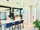 Modern kitchen featuring stainless steel appliances, center island with seating, and white cabinetry at 6237 Stable View St, Castle Pines, CO 80108