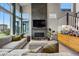 Bright living room with fireplace, large windows, and a comfortable sofa creates an inviting space at 6237 Stable View St, Castle Pines, CO 80108