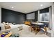 Media room with a large screen, comfortable seating, and a stylish dining area for entertaining at 6237 Stable View St, Castle Pines, CO 80108