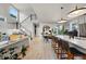 Open concept living space with modern decor, stylish island seating, and staircase at 6237 Stable View St, Castle Pines, CO 80108