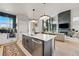 Bright, open-concept living space featuring modern kitchen island and a cozy living area at 6237 Stable View St, Castle Pines, CO 80108