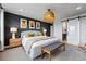 Comfortable main bedroom with stylish decor, sliding barn door, and accent wall at 6237 Stable View St, Castle Pines, CO 80108
