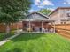 Large, landscaped backyard with a covered patio and outdoor seating area at 660 S Clarkson St, Denver, CO 80209