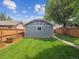 Backyard featuring a well-maintained lawn, planting bed, and fenced perimeter at 660 S Clarkson St, Denver, CO 80209