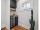 Compact bar area featuring sleek cabinets, a wine cooler, a decorative cactus, and a beverage preparation space at 660 S Clarkson St, Denver, CO 80209