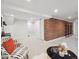 Spacious basement featuring a brick accent wall, carpet, and white trim at 660 S Clarkson St, Denver, CO 80209