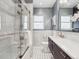 Modern bathroom features double shower head, dark vanity and decorative floor tiles at 660 S Clarkson St, Denver, CO 80209