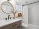 Bathroom featuring a shower/tub, modern vanity, updated faucet, and unique mirror at 660 S Clarkson St, Denver, CO 80209
