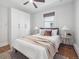 Bedroom features hardwood floors, two windows, ceiling fan, wardrobe and stylish furnishings at 660 S Clarkson St, Denver, CO 80209