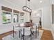 Dining room features wood floors, many windows, a modern light fixture and stylish chairs at 660 S Clarkson St, Denver, CO 80209