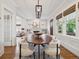 Bright dining room features a wooden table with stylish chairs, plus large windows at 660 S Clarkson St, Denver, CO 80209