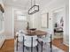 Stylish dining room with a modern chandelier, wood table, seating for six, and artistic decor at 660 S Clarkson St, Denver, CO 80209